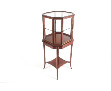 A mahogany and brass bijouterie cabinet, circa 1900, of octagonal form with single glass shelf and undertier, on swept feet, 