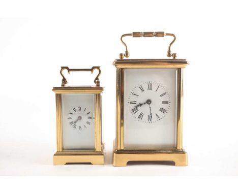 Two brass carriage clock timepieces, each with an enamel dial with Roman numerals, 8.5cm &amp; 11.5cm excl: handle