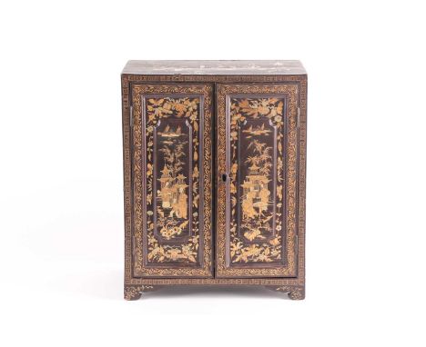 A 20th century Chinese black lacquer table-top jewellery cabinet, with five internal drawers, decorated throughout in gilt, 3