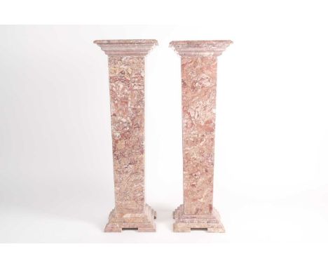 A pair of square section pink variegated marble pedestals. With moulded stepped bases and capitals. 102 cm high x 30 cm squar