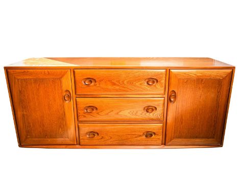 An Ercol golden dawn light elm sideboard with a central bank of drawers flanked by a pair of cupboard doors. 156 cm long x 43