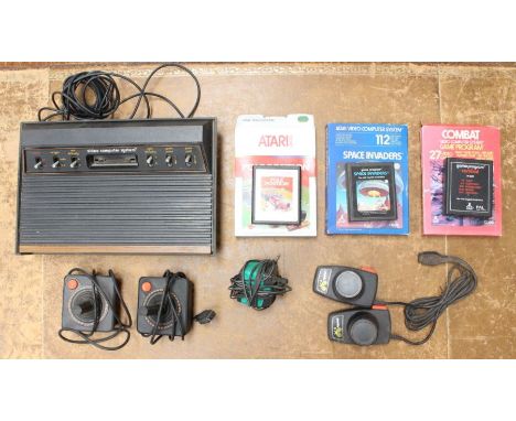 Atari: An unboxed Atari 2600 games console, together with three boxed games: Pole Position, Space Invaders and Combat with co