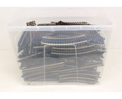Model Railway: A collection of assorted unboxed Atlas O Gauge 3-rail track sections including various straights and curves. G