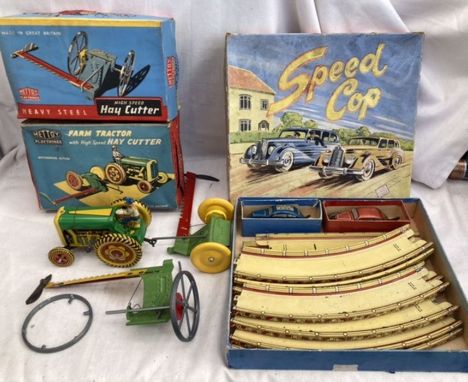 Tinplate: A vintage tinplate Tractor with Hay Cutter made in England by Mettoy, along with another Hay Cutter (broken wheel),