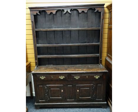 18TH CENTURY WELSH OAK HIGH DRESSER, the boarded delft rack with card cut and hollow cornice supporting three shelves between