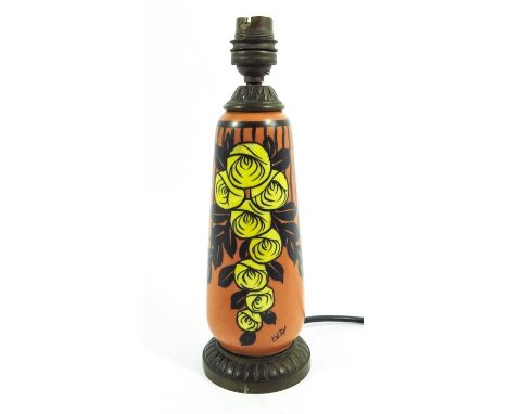 A French Art Deco ceramic table lamp, orange ground rounded cylinder form with metal mounts, painted with stylised rose motif
