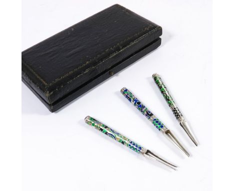 A set of three Russian silver an enamelled caviar forks, cloisonne enamel with bi pronged terminals, 8.5cm long, 0.5ozt