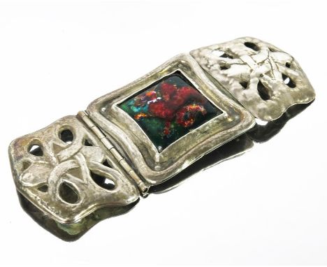 Nelson and Edith Dawson, an Arts and Crafts silver and enamelled buckle, the square enamel plaque of a collared wyvern in red