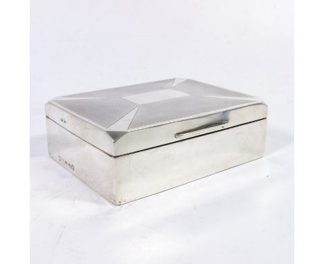 An Art Deco silver cigar casket, Birmingham 1935, radiating light ray and engine turned design, with chamfered corners, cedar