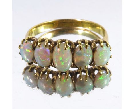 A five stone opal and gold ring, graduated cabochon stones, approx. size K 1/2