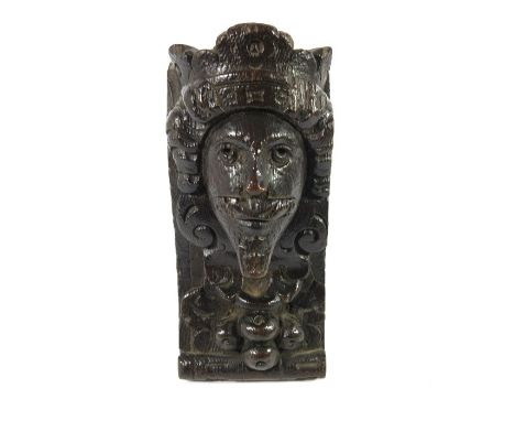 A 17th century or later carved oak bracket, modelled as the head of Charles I with Renaissance foliate and fruit motifs, 16.5