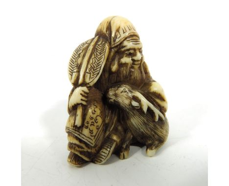 λ A 19th century Japanese ivory netsuke, Meiji, modelled as an elderly man with deer, 3.5cm long