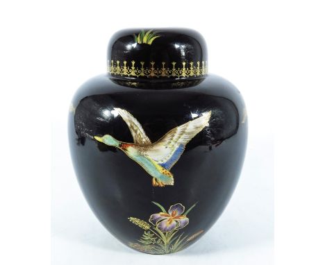 A Carlton Ware lamp base, ginger jar form, black ground with enamelled and gilt mallards in flight over irises, 16cm high