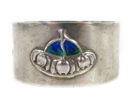 David Veasey for Liberty and Co., an Arts and Crafts silver and enamelled napkin ring, Birmingham 1910, embossed with stylise