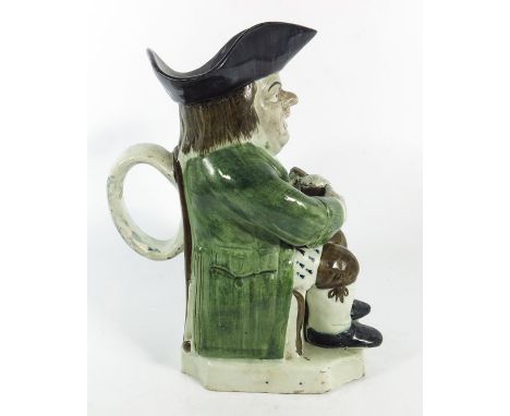 A Staffordshire Toby Jug, 18th century, modelled wearing a green coat, 24.5cm high