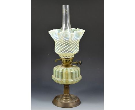 An Arts and Crafts straw opal glass oil lamp, the shade probably by James Powell and Sons, Whitefriars, wrythen opaque traili