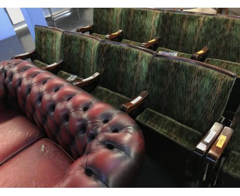 A single row of four vintage cinema seats