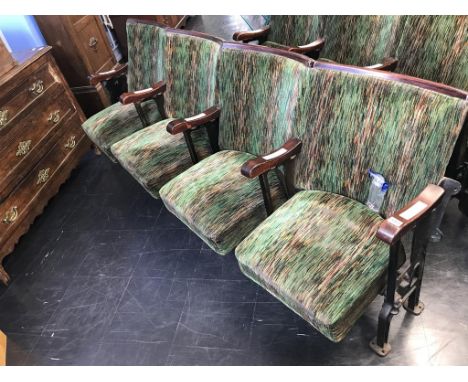 A single row of four vintage cinema seats