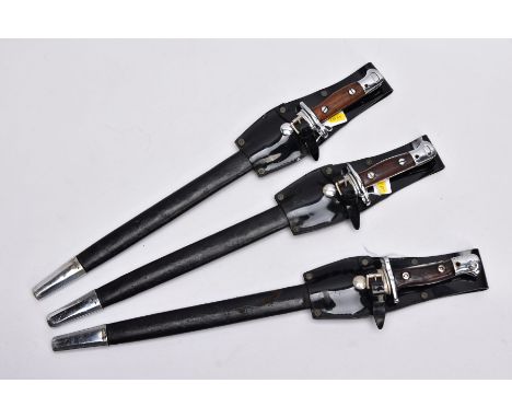 THREE X 1907 PATTERN SMLE DRESS BAYONETS, in high gloss belt frogs and scabbards, the grips being wooden with chromed fitting