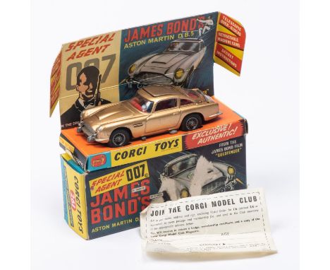 A Corgi Toys James Bond Aston Martin DB5 (261). First version in metallic gold with passenger. Boxed with inner display stand