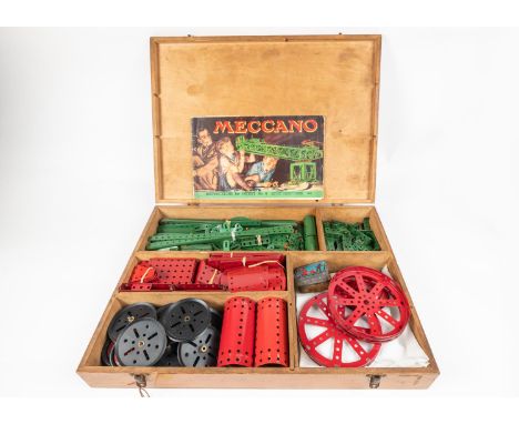 A Meccano branded wooden boxed set, major parts from Outfit No.6. Red and green components including plates, strips, cylinder
