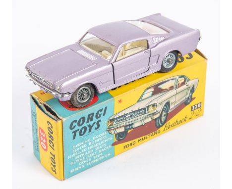 Corgi Toys Ford Mustang Fastback 2+2 (320). In metallic lilac with cream interior, example with spoked wheels. Boxed, minor w