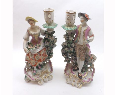 Pair of Derby Porcelain Candlestick figures of a flower seller and his female companion, each painted throughout in colours a