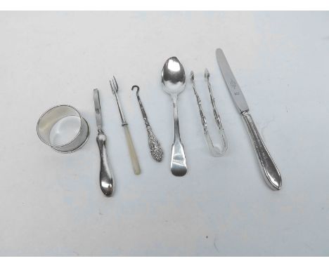 A Mixed Lot comprising: a hallmarked Silver Napkin Ring, Silver-Handled Tweezers, Silver Sugar Nips, Mother-of-Pearl Handled 