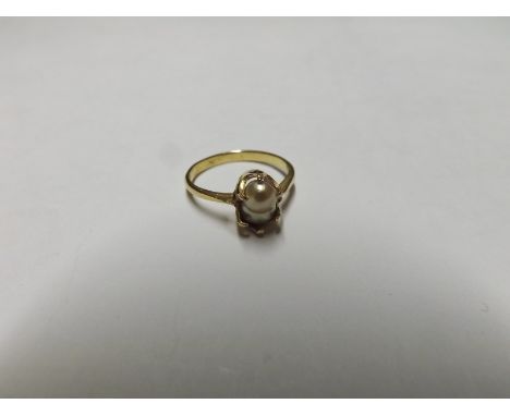 Unmarked yellow metal Ring, claw set with a single Pearl  