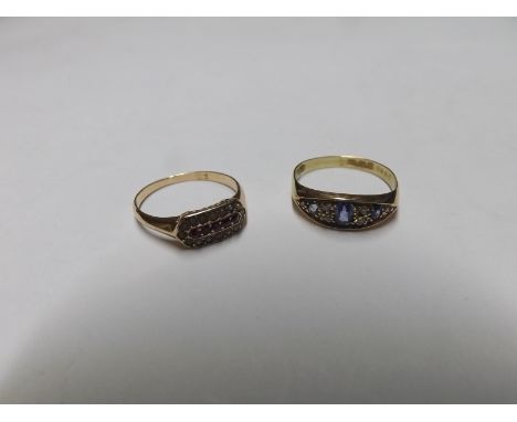 Early 20th Century hallmarked 18ct Gold Ring, the boat shaped setting featuring three oval light blue Sapphires and four smal