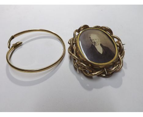 A 20th Century hallmarked 9ct Gold Dolphin design Bangle, weighing 5 1/2 gm; together with a Victorian Pinchbeck Framed Swive
