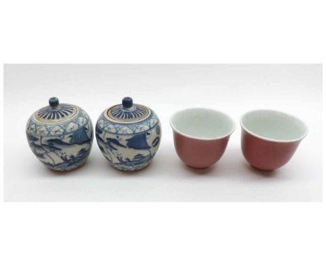 A pair of Oriental Cups of tapering circular form, decorated in the Sang de Boeuf manner, together with a further pair of Chi