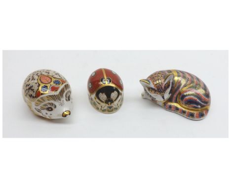 Three Royal Crown Derby Paperweights: Sleeping Kitten (gold button); Ladybird with seven spots (silver button); Bramble Hedge