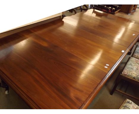 Victorian Mahogany extending Dining Table of rectangular form with two extension leaves, raised on tapering legs with carved 