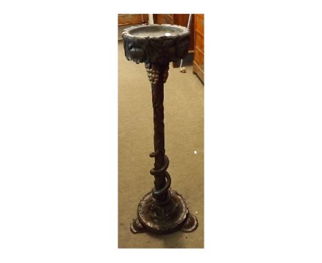 Unusual 19th Century carved Wine Stand, the body decorated with entwined snake and foliage and grapes, raised on three squat 
