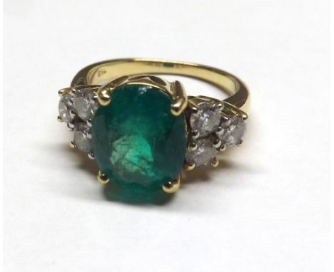 18ct Diamond and Emerald seven stone ring. Central emerald measuring 10mm x 8mm approx. 3 diamonds to each side of the emeral