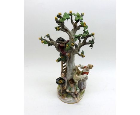 A Meissen Group of children picking apples in a tree with a ladder and a young girl with apples in the fronds of her apron, p