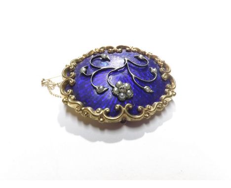 Victorian Pinchbeck framed shaped oval Brooch with scrolled edge, the blue enamelled centre featuring a wire work and Seed Pe