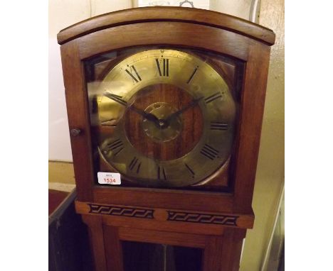 A first half of 20th Century Walnut cased, electric, floor standing Timepiece in case with lift off hood over a single glazed