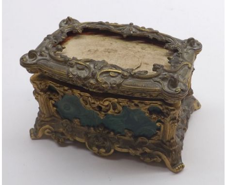 A 19th Century Gilt Metal Trinket Box of hinged rectangular form, decorated all over with scrolled metalwork, raised on four 