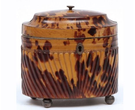 An early 19th Century Oval Tortoiseshell Tea Caddy, hinged lid and the interior with single pull-off cover, the body with rib