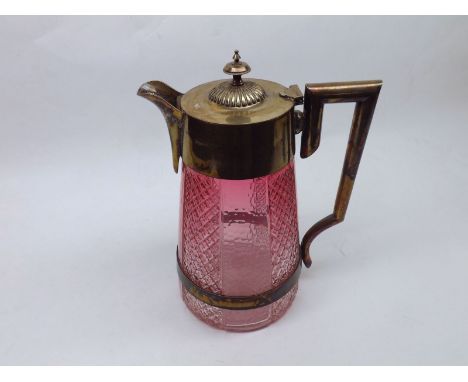 A late 19th or early 20th Century Water Jug with silver plated mounts and light cranberry cut glass body, 10" high  