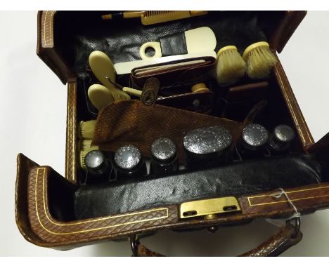 A good quality leather cased Travelling Vanity Set, the case with hinged lid and marked "Lund Maker Cornhill London", the int