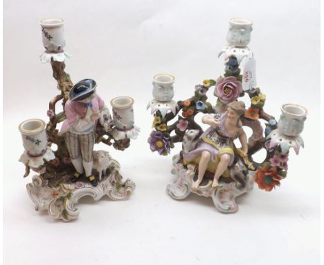 Two early 20th Century Continental three-light Candelabras, both elaborately decorated with central figure, floral encrustati