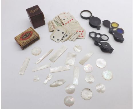 A Mixed Lot comprising: boxed miniature playing cards, folding magnifying glasses, cased poker dice, mother-of-pearl gaming c