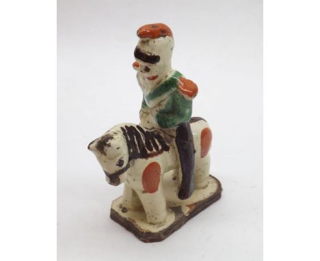 Na ve pottery figure of mounted soldier on horseback wearing a green sash and with iron red epaulettes and cap, 4 1/2" high 