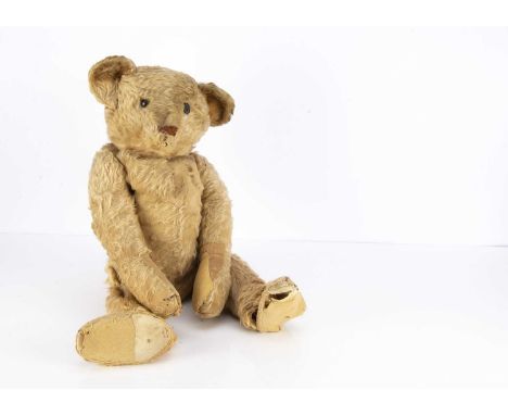 A large early German Teddy Bear circa 1910,  with golden mohair, one black boot button eye, pronounced muzzle, black stitched