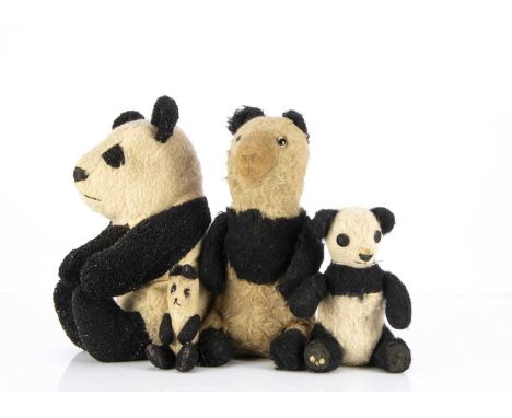 Four English Pandas, comprising of a wool plush, with clear and black glass stick eyes, unjointed in a seated position —12in.