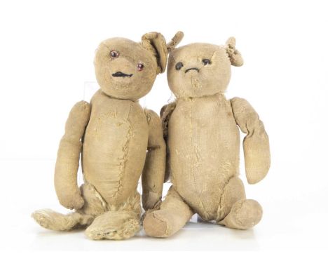 Two 1920's teddy bears, one with black boot button eyes, remains of black stitched nose, swivel head and jointed limbs with i