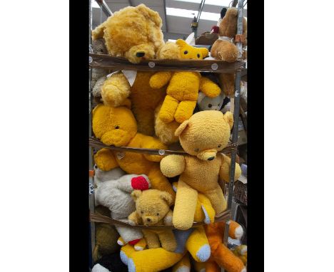 A very large selection of unjointed teddy bears,  in a variety of sizes and colours, including a Real Soft Toy, with arm in s